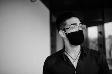 Middle eastern entrepreneur wear black face mask and eyeglasses. New normal life after coronavirus...
