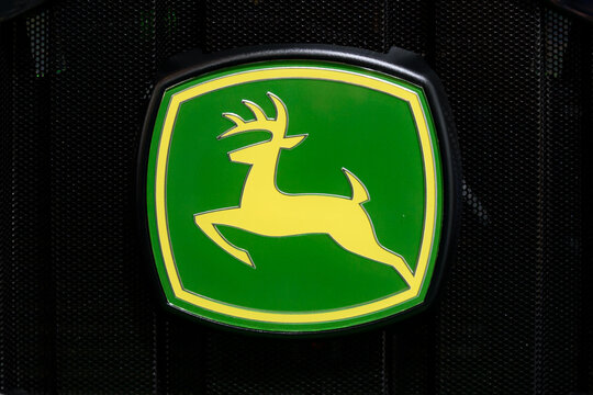 Kielce, Poland, March 16, 2019: John Deere sign on front of a tractor grill. Deere & Company is a famous American manufacturer of agricultural machines and vehicles.