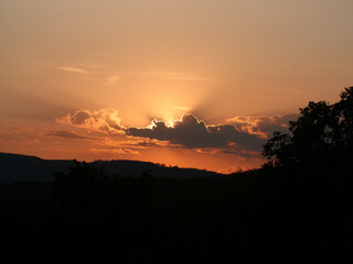 Sunset Hochtaunus Hessen, clouds hide the sun in the dusk.