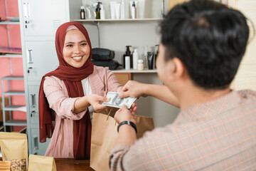 young men buy these packaged products to woman and make payment