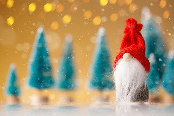 Cute christmas gnome is sitting and waiting for his presents for christmas