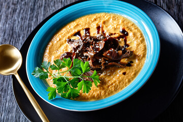 Pumpkin soup with wild mushrooms broth, top view