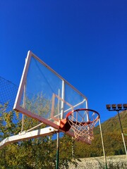 Fototapeta na wymiar basketball hoop on mountains background