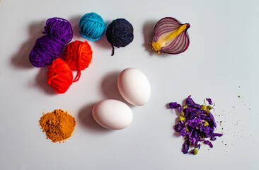 Ethnic traditional egg coloring kit for Easter - colorful yarn ball, onion peels, curcumin, flowers and white eggs
