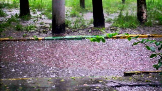 drops of summer or autumn rain of water fall on asphalt in the city turning into a large puddle, flooding the street. Drops of rain fall. slow motion, general paln