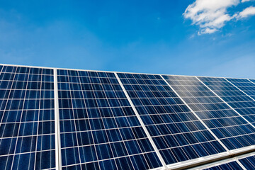 Obraz premium A solar panel with blue sky and small cloud.