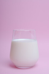  glass with milk on a pink background