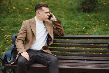 Stylish elegant men man in coat in urban style