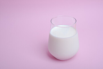  glass with milk on a pink background