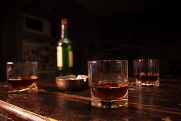 cigarette smoking and drinking alcohol. Glass of whiskey, cigarettes and ashtray