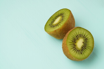 two halves of kiwi on a green background