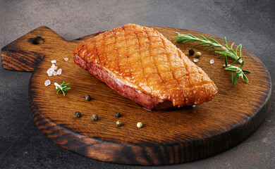 Roasted duck breast on chopping board.