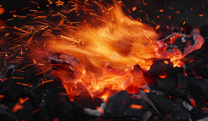 flying sparks, glowing embers of charcoal on a grill