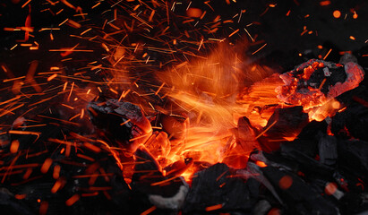 flying embers of charcoal on a grill, flying sparks, glowing charcoal, glowing embers