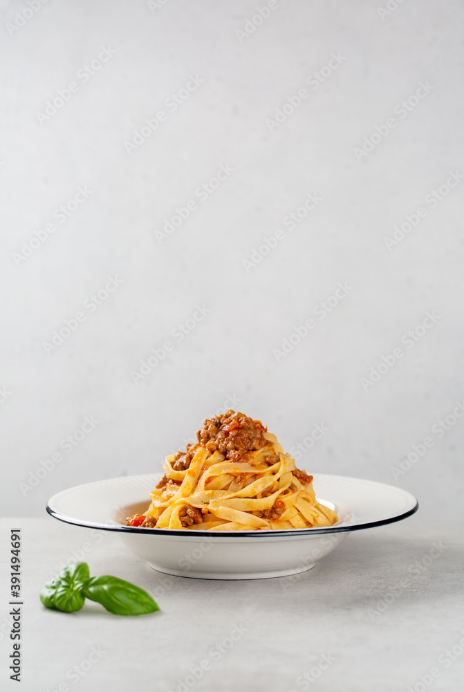 Poster Plate with italian pasta Tagliatelle al ragu with bolognese sauce, vertical image, copy space.