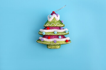 Creative layout with a Christmas tree on a bright blue background. Minimal winter nature holiday scene.