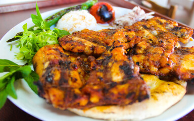 Grilled chicken wings with vegetables on a plate