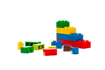 Multi-colored plastic building blocks. Toys and games. Focus in the background.