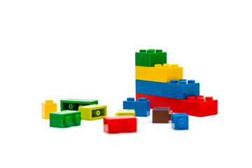 Obraz premium Multi-colored plastic building blocks. Toys and games. Focus in the background.