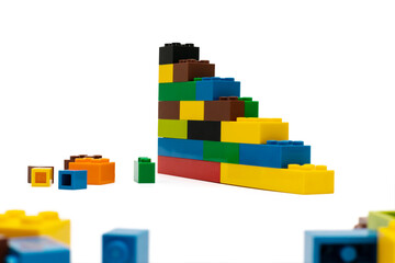Obraz premium Multi-colored plastic building blocks. Toys and games. Focus in the background.