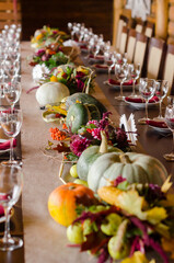 Festive autumn dinner in a restaurant decoration with pumpkins and fallen leaves beautiful background