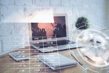 Stock market chart hologram drawn on personal computer background. Double exposure. Concept of investment.