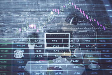 Double exposure of graph and financial info and work space with computer background. Concept of international online trading.