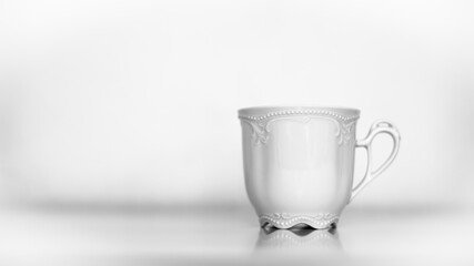 Expensive, decorated, white porcelain tea cup. Shallow depth of field photography.