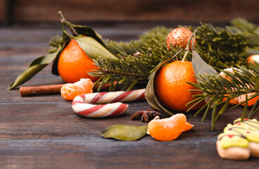 tangerine,  Lollipop,  spruce branch on a dark wooden