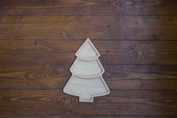 Wooden Christmas tree on dark wooden background