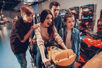 The son supports the mother who drives motorcycle.