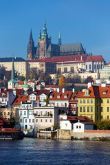 Obraz premium Autumn colorful Prague Lesser Town with gothic Castle above River Vltava in the sunny Day, Czech Republic