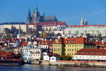 Obraz premium Autumn colorful Prague Lesser Town with gothic Castle above River Vltava in the sunny Day, Czech Republic
