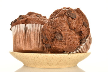 A few delicious chocolate muffins, close-up, on a white background.