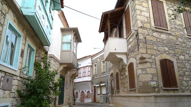 narrow street with historical stone houses, alacati, izmir
