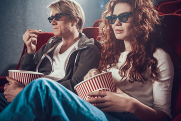 Fototapeta premium Beautiful woman with a man sitting in the cinema.