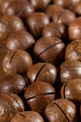 Heap of macadamia nuts as background. Food background. Close-up.