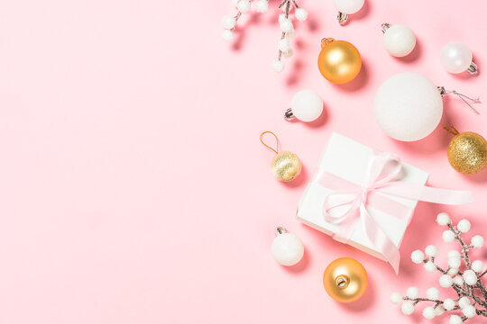 Christmas pink flat lay background with holiday decorations.