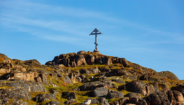 Orthodox cross on the mountain in Teriberka. Kola Peninsula, Russia.
