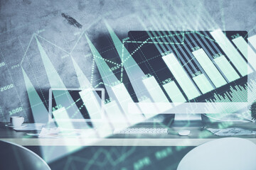 Financial chart drawing and table with computer on background. Multi exposure. Concept of...