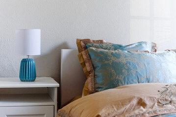 Side table with white lamp in the bedroom