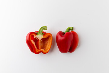Top view raw red bell pepper sliced half on white table. Healthy vegetables and food.