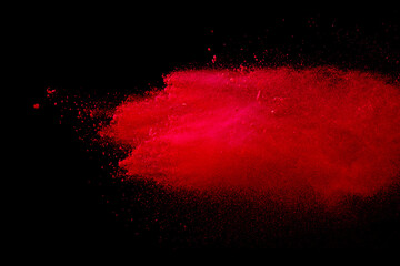 Red powder explosion on black background.