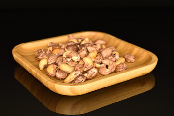 Fragrant roasted cashews, close-up, on a black background.
