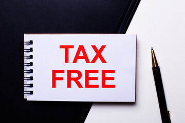 TAX FREE written in red on a black and white background near the pen