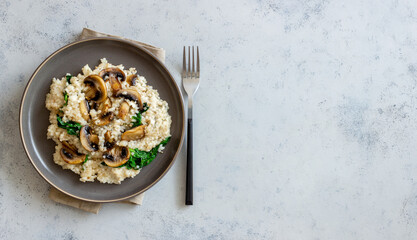 Risotto with mushrooms and spinach. Healthy food. Vegetarian food. - Powered by Adobe