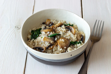 Risotto with mushrooms and spinach. Healthy food. Vegetarian food.