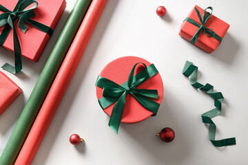 Christmas wrapping gifts with red and green decoration on grey. Preparation for Xmas holidays. Top...