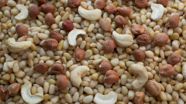 A Lot of Useful Pine Nuts, Hazelnuts Cashew, Close-up, Top View. Background of Peeled Nuts. The Concept of a Healthy Diet and Proper Vitamin Diet with Protein.