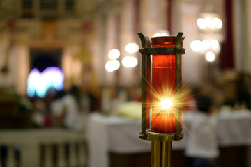 Votive candle lit inside a church representing divine light.Divine light.